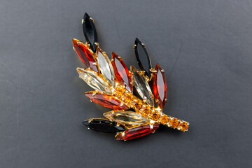 Vintage crystal brooch on black background, old accent retro rhinestone jewelry for women, promotional photo for an online jewellery store