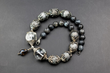 Gray gemstone crystal beads necklace on black, unique handmade jewelry background