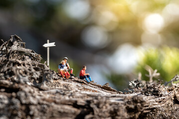 People taking break while enjoying hike in forest
