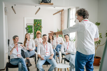 Fototapeta na wymiar coach training speak explain question to group of employees at seminar