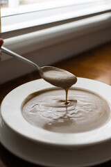 Creamy Truffle Mushroom Soup with Spoon by a Window