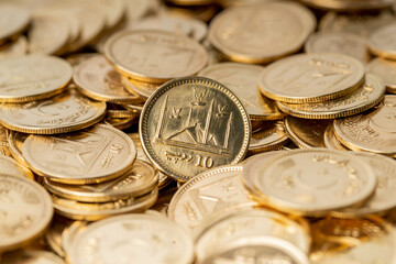 Stacks of gold coins of Pakistani currency symbolize wealth and prosperity