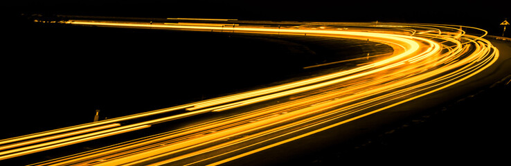 orange car lights at night. long exposure