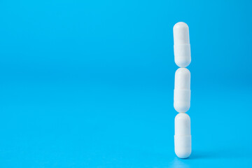 A tower of medical pills balancing