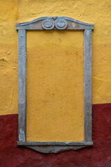 Empty frame Rustic Colonial mexican street, stone frame yellow and red wall.