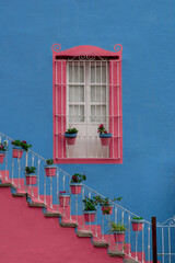 Mexican Classic Colonial Style Window and stairs, pink and blue colors in Guanajato Mexico.