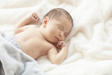 Cute newborn baby during care procedures.