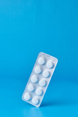 A blister pack with medicine tablets balancing