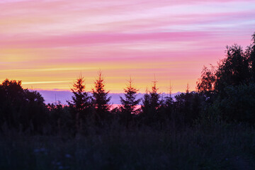 Sunset in the countryside. Summer evening. Bright sky.