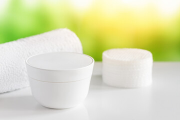 White cream in a jar. Spa procedures. Towel