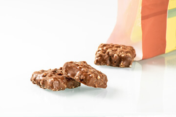 Wafer cakes with hazelnut cream filling in whole milk chocolate on a white background
