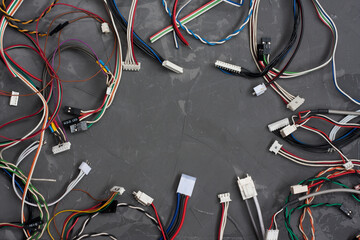 Colored cables and wires with connectors on gray concrete background. colorful different computer...