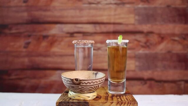shots of gold, silver and mezcal tequila in different types of glass. mexican drink
