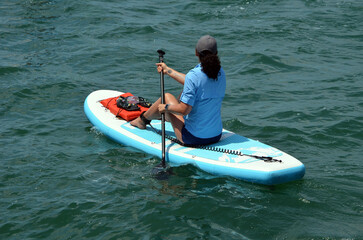 Young black woman on a paddle board