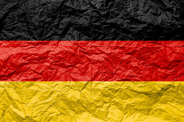 Flag of Germany on crumpled paper. Textured background.