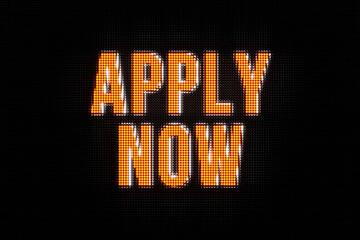 Apply now. The text in orange, led screen. Applying, hiring, motivation, opportunity, recruitment, trainee, for hire sign, job search.