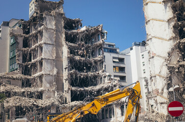 Building demolition in residental area excavator machine on construction site - 613997019