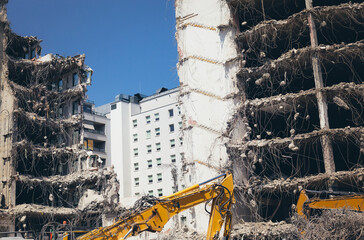Building demolition in residental area excavator machine on construction site