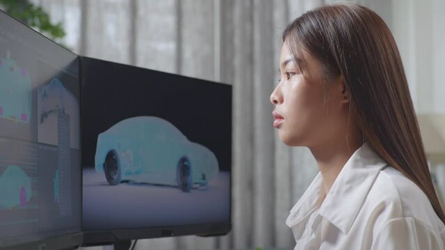 Close Up Side View Of Asian Female Automotive Designer Shaking Her Head Being Tired Working On 3D Model Of Ev Car On The Desktop Computers In The Studio
