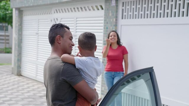 Divorced couple sharing custody of children. Father returning son to his mom after weekend. Shared custody concept 
