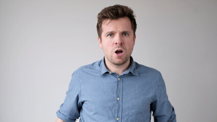 young man looks fearfully and bewilderedly into the camera