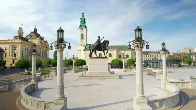 Areal drone view of the Unirii Square in Oradea downtown, Romania. King Ferdinand I statue, Saint Ladislaus Church and Town Hall, walking people