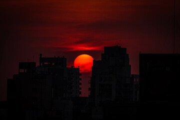 El sol se posa entre 2 edificios al atardecer