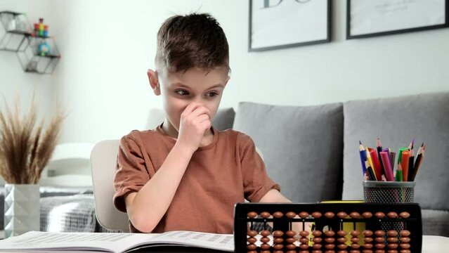 Little preschooler counting large numbers on his fingers using mental arithmetic, concept of child development