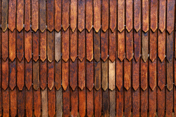 Rough textured wood carving surface imitating the roof of a house. Background or backdrop. Design blank