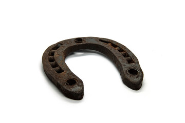 Horseshoe covered with rust on a white background