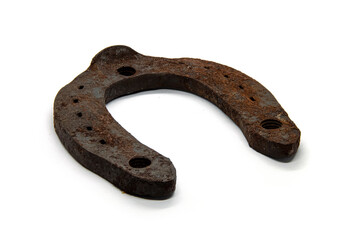 Metal horseshoe covered with rust on a white background