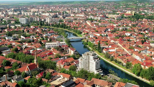 Aerial drone view of Oradea downtown, Romania. Cityscape with multiple historical buildings made in classic style, Crisul Repede river, greenery