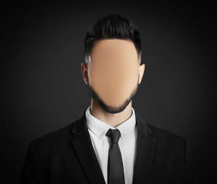Anonymous. Faceless man in suit on dark background