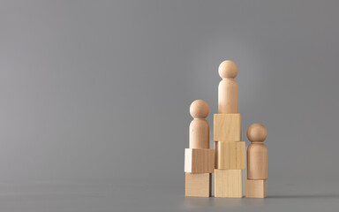 Wooden Human standing on podium with ranking for winner business and sport competition concept, on...