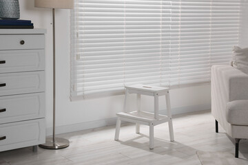 White compact ladder near window at home