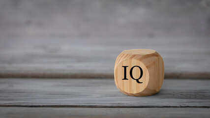 IQ, intelligence concept. Abstract geometric wooden dice isolate with a IQ icon on white rustic...