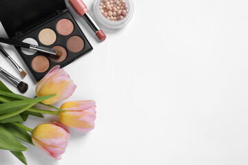 Obraz na płótnie Canvas Flat lay composition with different makeup products and beautiful tulips on white background, space for text