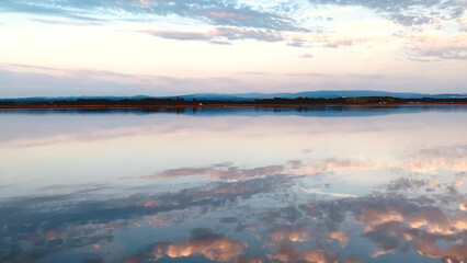 Clouds reflection on calm water surface