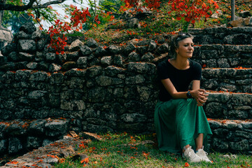 Hiker woman looking at ancient Mayan ruins