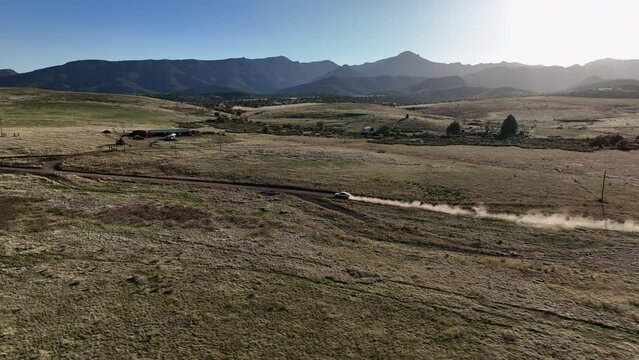 Drone shot of car driving on dirt road in Willcox, Arizona, tracking aerial shot