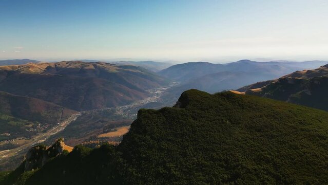 drone rotate around scenic mountains peak in pietra arsa mountains prahova valley Romania