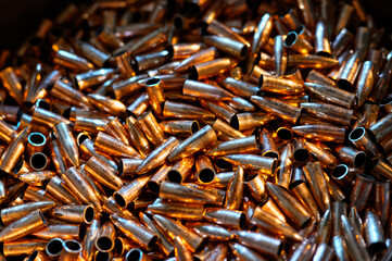 Large caliber copper shells pile for riffle as background