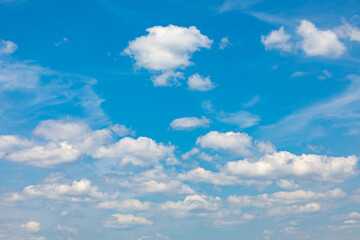 Naklejka na ściany i meble scenic blue sky with soft puffy clouds.
