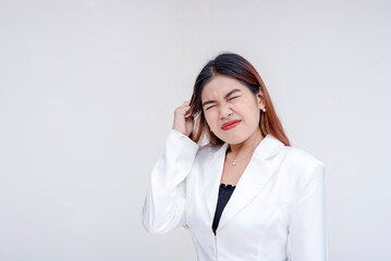 A frustrated and irritated young woman pulling her hair in annoyance. Isolated on a white background.