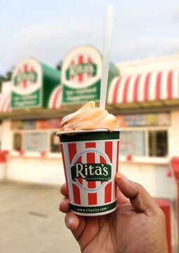 Wilmington, Delaware, U.S - June 16, 2023 - Holding a Rita's Tangerine Gelati with orange creamsicle custard