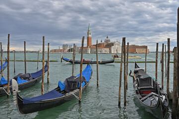 Gondolas on a rainy Venice day. © Ken