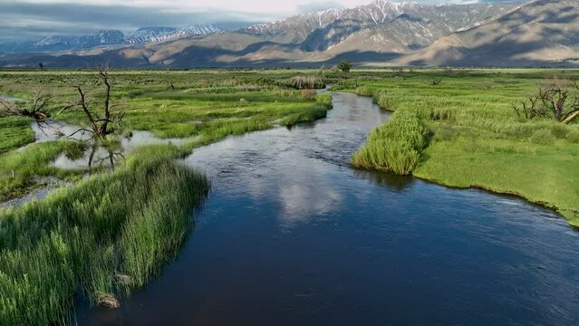 Sun and clouds reflect off Owens River Daybreak Backtrack