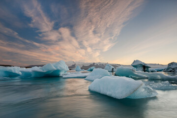 icebergs floating towards the north atlantic ocean in the glacier lagoon jokulsarlon in south...