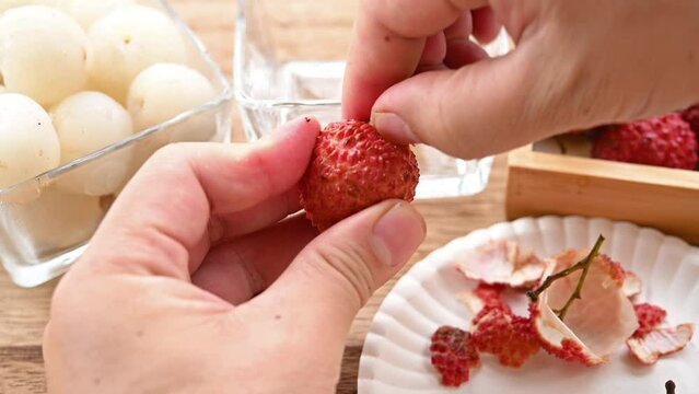 peeling fresh lichees at horizontal composition