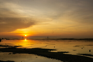 View of the beach at low tide at sunrise